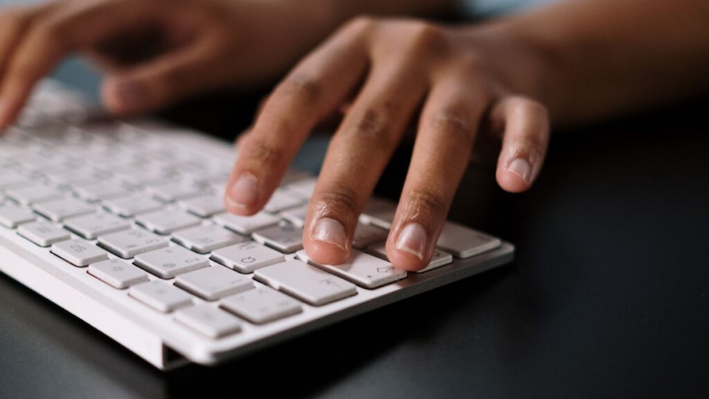 Hands on a keyboard during a website accessibility check